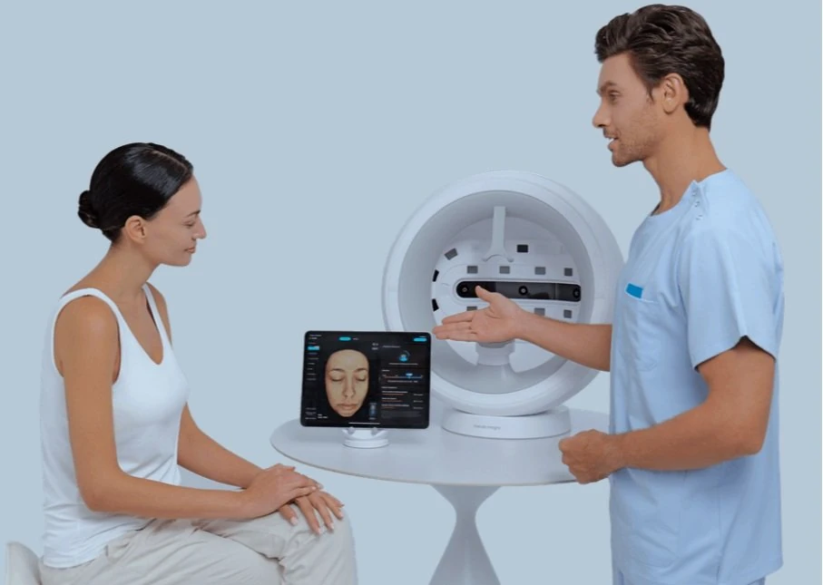 EveLab skin analysis: a seated woman faces a scanner while a clinician reviews her face on a screen